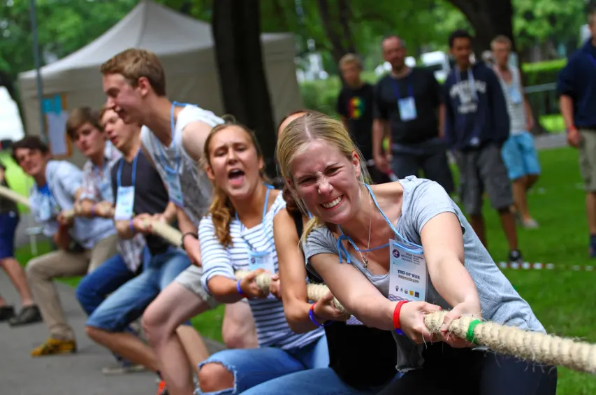 Group of employees playing tug-of-war at an off-site outing.